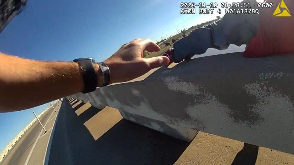 Video captures split-second rescue when officer catches man falling off bridge; Watch