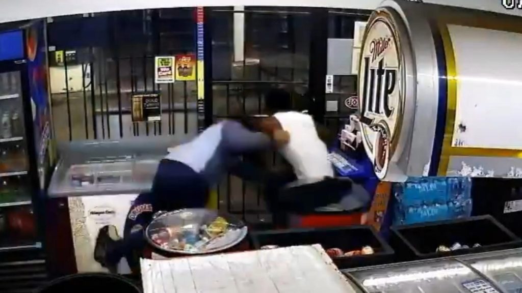 Video show store clerk fighting back against armed robbery suspect near downtown Houston